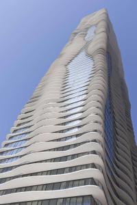 a tall building with a blue sky in the background at Radisson Blu Aqua Hotel, Chicago in Chicago