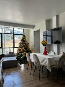 una sala de estar con un árbol de Navidad y una mesa y sillas en Tu hogar en Abancay, en Abancay