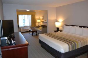 a hotel room with a bed and a television at Country Inn & Suites by Radisson, Gurnee, IL in Gurnee