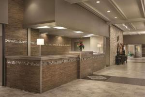 a lobby with a reception desk in a building at Radisson Hotel Louisville North in Jeffersonville