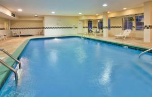 a large swimming pool in a hotel room at Country Inn & Suites by Radisson, Bloomington-Normal West, IL in Bloomington