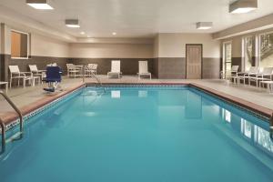 a pool with blue water in a hotel room at Country Inn & Suites by Radisson, Indianapolis South, IN in Indianapolis