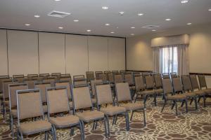 a room with a bunch of chairs in it at Country Inn & Suites by Radisson, Garden City, KS in Garden City