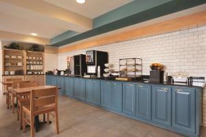 a kitchen with blue cabinets and a counter top at Country Inn & Suites by Radisson, Bowling Green, KY in Bowling Green