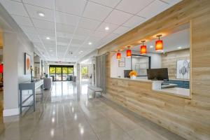 an office lobby with a wooden accent wall at Country Inn & Suites by Radisson, New Orleans I-10 East, LA in New Orleans