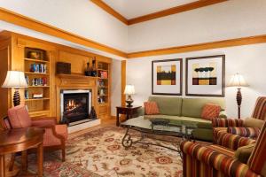 a living room with a couch and a fireplace at Country Inn & Suites by Radisson, Bel Air-Aberdeen, MD in Bel Air