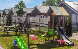 a playground with slides and a play structure at Gorgeous Home In Ustronie Morskie With Kitchen in Ustronie Morskie