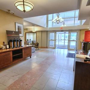 a large lobby with a large room with a large window at Country Inn & Suites by Radisson, Dearborn, MI in Dearborn