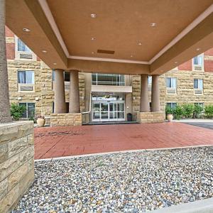 a large building with a red brick patio in front of it at Country Inn & Suites by Radisson, Dearborn, MI in Dearborn