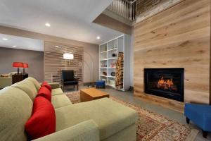a living room with a couch and a fireplace at Country Inn & Suites by Radisson, Houghton, MI in Houghton