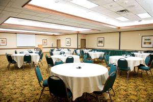a room filled with tables and chairs with white table cloth at Country Inn & Suites by Radisson, Chanhassen, MN in Chanhassen