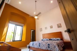 a bedroom with a bed and a window at Viveza - Downtown in Campeche