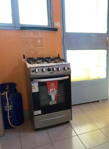 a stove in the corner of a kitchen at Ouedraogo Property Management in Ouagadougou