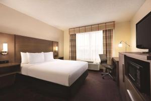 a hotel room with a bed and a television at Country Inn & Suites by Radisson, Forest Lake, MN in Forest Lake +22 photos