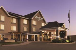 a hotel building with a sign on the front of it at Country Inn & Suites by Radisson, Albert Lea, MN in Albert Lea