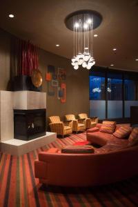 a living room with a couch and a fireplace at Radisson Hotel Duluth-Harborview in Duluth