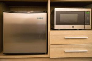 a stainless steel refrigerator next to a microwave at Radisson Hotel Duluth-Harborview in Duluth