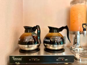 two coffee pots sitting on top of a box at King Park Hotel Kota Kinabalu in Kota Kinabalu