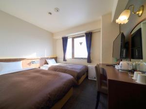 Postel nebo postele na pokoji v ubytování Minakuchi Century Hotel