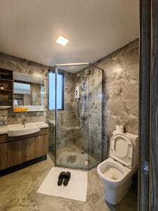 a bathroom with a shower and a toilet and a sink at Xtu Golf Villa Forest City二房独栋别墅 in Gelang Patah