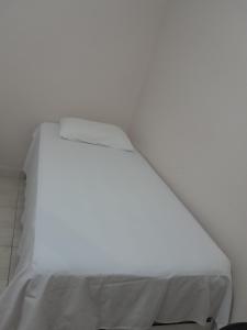 ein weißes Bett in einem weißen Zimmer in der Unterkunft Hotel e Restaurante São Cristovão 