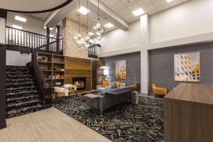 a lobby with a staircase and a fireplace at Country Inn & Suites by Radisson, Lake Norman Huntersville, NC in Huntersville