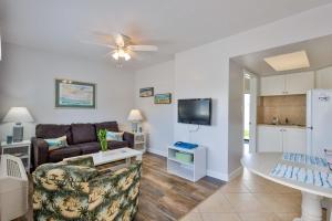 a living room with a couch and a table at Coastal Waters 106 - A 1-1 Pool Side Retreat in New Smyrna Beach