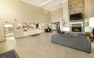 uma grande sala de estar com sofás e uma lareira em Country Inn & Suites by Radisson, Grand Forks, ND em Grand Forks