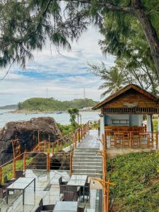 a restaurant with stairs leading to the water at Resort Bai Xep Quy Nhon in Quy Nhon