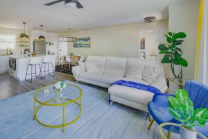 a living room with a white couch and a table at Manchaca Meadows - 4 Bedroom Villa in Manchaca