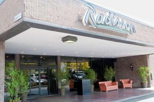 a restaurant with a sign on the front of it at Radisson Hotel Corning in Corning