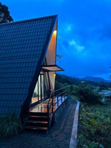 a house with a pitched roof and a deck at A frame Riverston in Matale