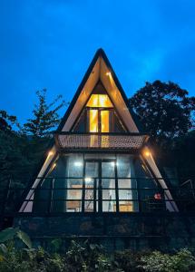 a small tree house with a window at night at A frame Riverston in Matale