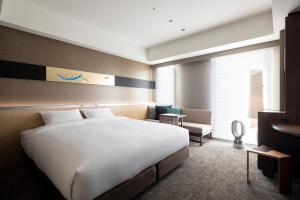 a large white bed in a hotel room at Cross Hotel Kyoto in Kyoto