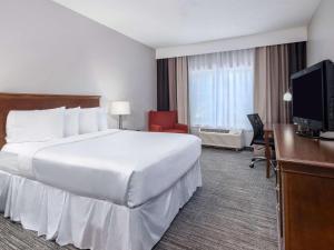 Una cama o camas en una habitación de Country Inn & Suites by Radisson, Toledo, OH