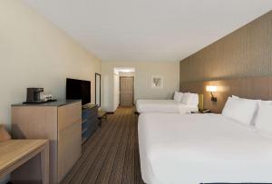 a hotel room with two beds and a flat screen tv at Country Inn & Suites by Radisson, Findlay, OH in Findlay