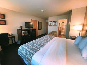 a hotel room with a large bed and a television at Country Inn & Suites by Radisson, Bend, OR in Bend
