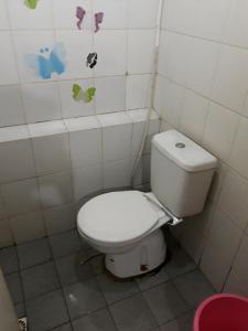a bathroom with a white toilet in a room at Kalibata city apartemen tower akasia in Jakarta