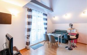 a living room with a table and a couch at Awesome Apartment In Zarnowska With Heated Swimming Pool in Żarnowska