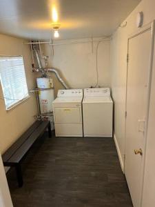 a small kitchen with two washers and a stove at New 2BR 1Bath w/ Free Parking & Laundry near University of Berkeley in Richmond