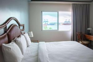 a hotel room with a bed and a window at Radisson Colon 2,000 Hotel & Casino in Colón