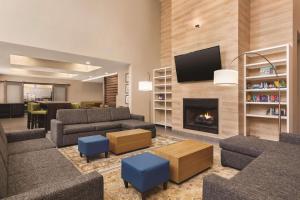 a living room with a couch and a fireplace at Country Inn & Suites by Radisson, Beaufort West, SC in Beaufort