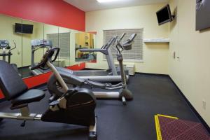 a gym with several cardio machines in a room at Country Inn & Suites by Radisson, Watertown, SD in Watertown