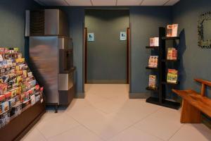 a store aisle with a refrigerator in a store at Country Inn & Suites by Radisson, Nashville Airport, TN in Nashville