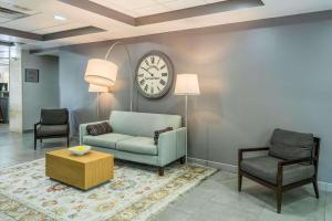 a living room with a couch and a clock on the wall at Country Inn & Suites by Radisson, Cookeville, TN in Cookeville