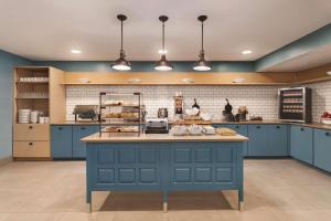 a kitchen with blue cabinets and a blue island at Country Inn & Suites by Radisson, Sevierville Kodak, TN in Kodak