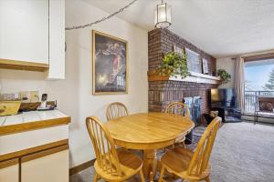 a kitchen and dining room with a wooden table and chairs at Ski on ski off, conveniently located, 2 bedroom condo with beautiful views, access to indoor pool Sunrise B3 in Killington