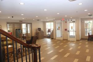 a lobby with a staircase and a stair case at Country Inn & Suites by Radisson, Nashville, TN in Nashville +37 photos