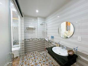 a bathroom with a sink and a mirror at Sky Star 2 Hotel in Can Tho