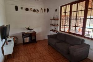 a living room with a couch and a tv at Casa de campo Villa Siles in Pucusana